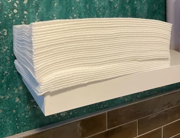Enki towels on a shelf at Saks