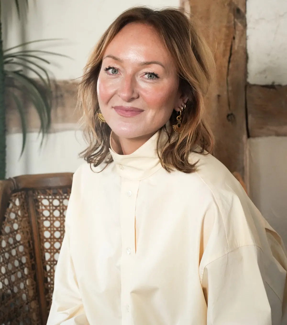 Susannah Richardson from Butchers Salon smiles for the camera in a white blouse.