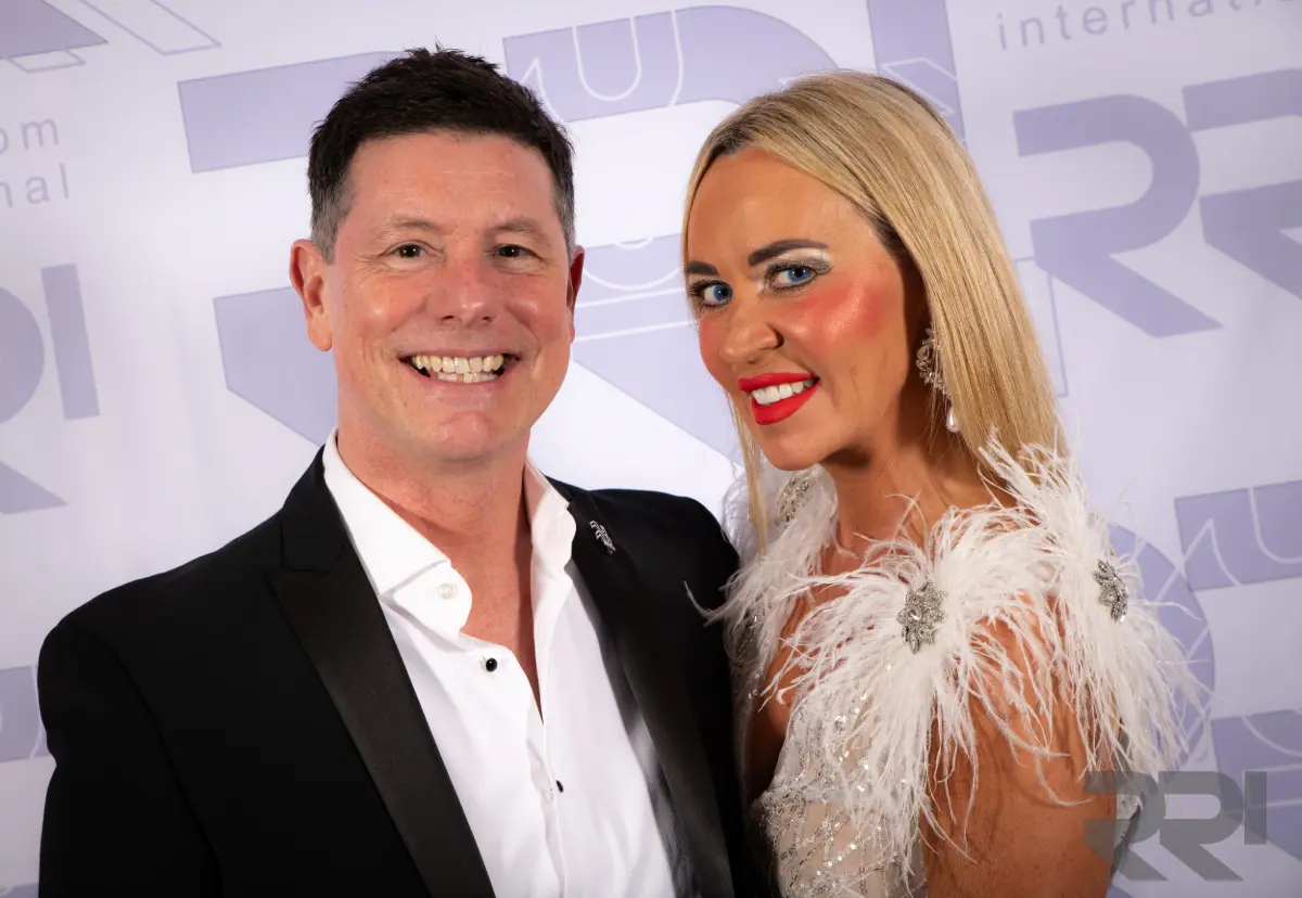 Wil and Shannon Fleeson stand together for a photo at an event.