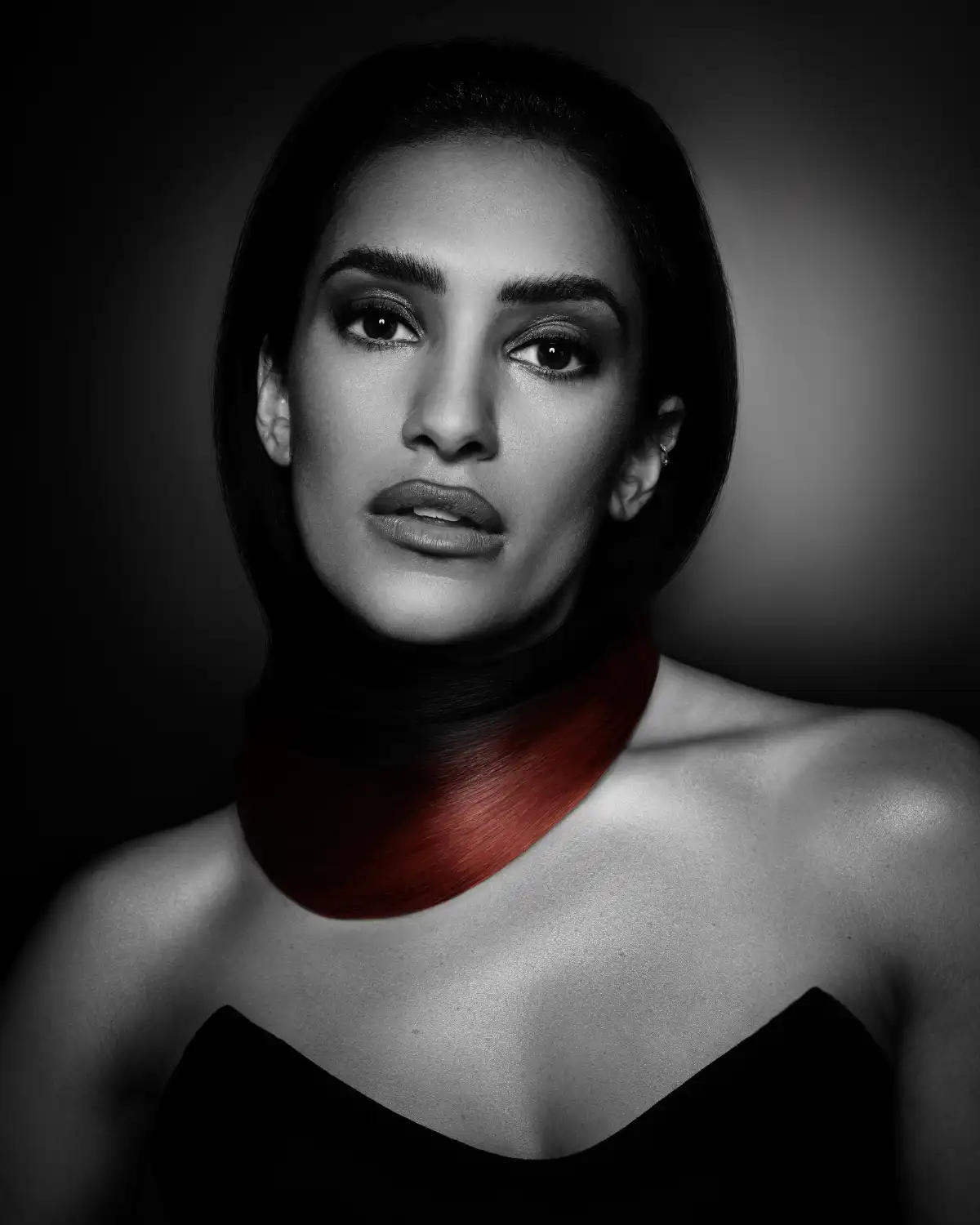 Sleek black bob with a sculpted red accent around the neckline from Niall McNulty's Accent Collection, celebrating shape and contrast.