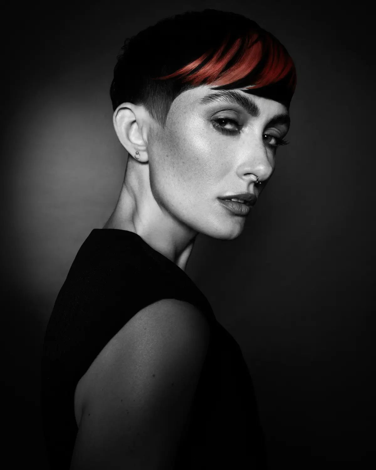 Short textured pixie cut with a sweeping red fringe from Niall McNulty's Accent Collection, celebrating shape, contrast and simplicity.