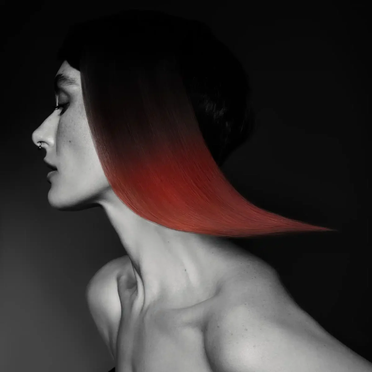 Sleek red geometric bob with a sharp, sculpted shape from Niall McNulty's Accent Collection, celebrating contrast and simplicity.