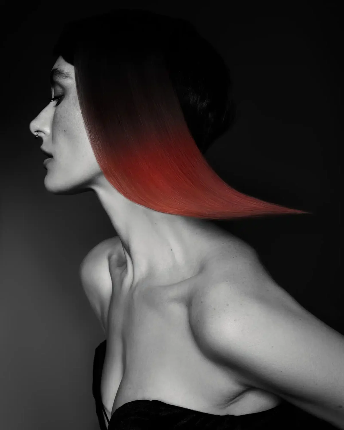 Sleek red geometric bob with a sharp, sculpted shape from Niall McNulty's Accent Collection, celebrating contrast and simplicity.