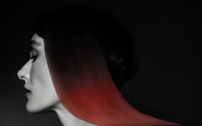 Sleek red geometric bob with a sharp, sculpted shape from Niall McNulty's Accent Collection, celebrating contrast and simplicity.