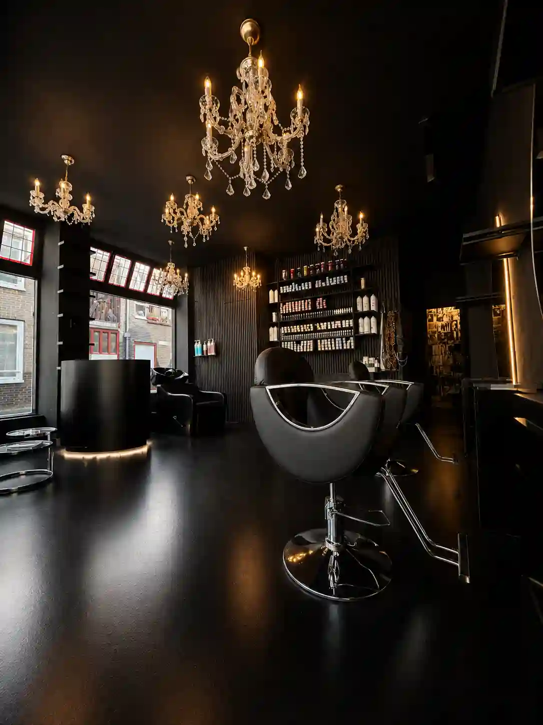 Swivel chairs and chandeliers in the Larisa Love Amsterdam salon.