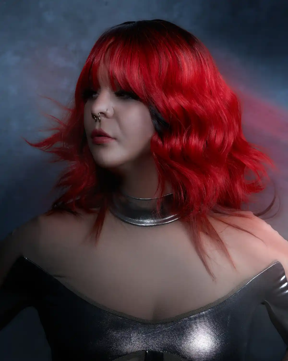PRISM by William and Bianca Gray featuring a vivid red layered haircut with full fringe, movement and glossy texture.