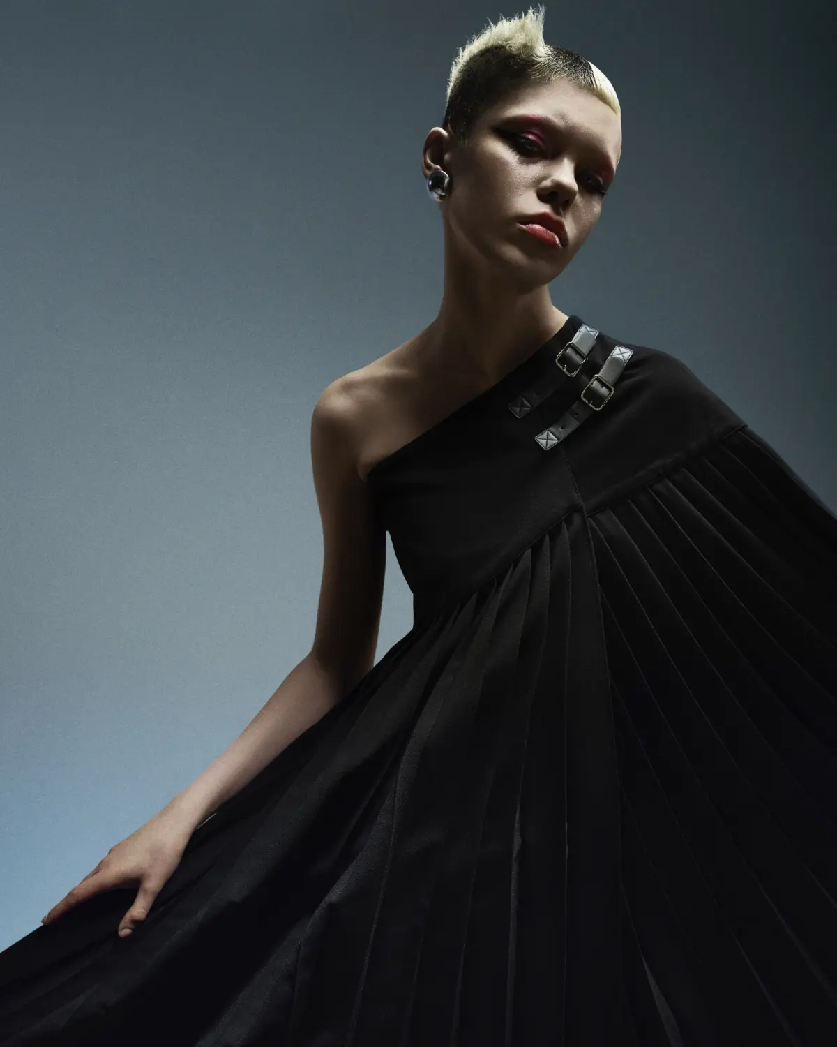 Model with short blonde hair and wears black ball gown exploring refined simplistic beauty with the Eclipse collection by Marlon Hawkins.