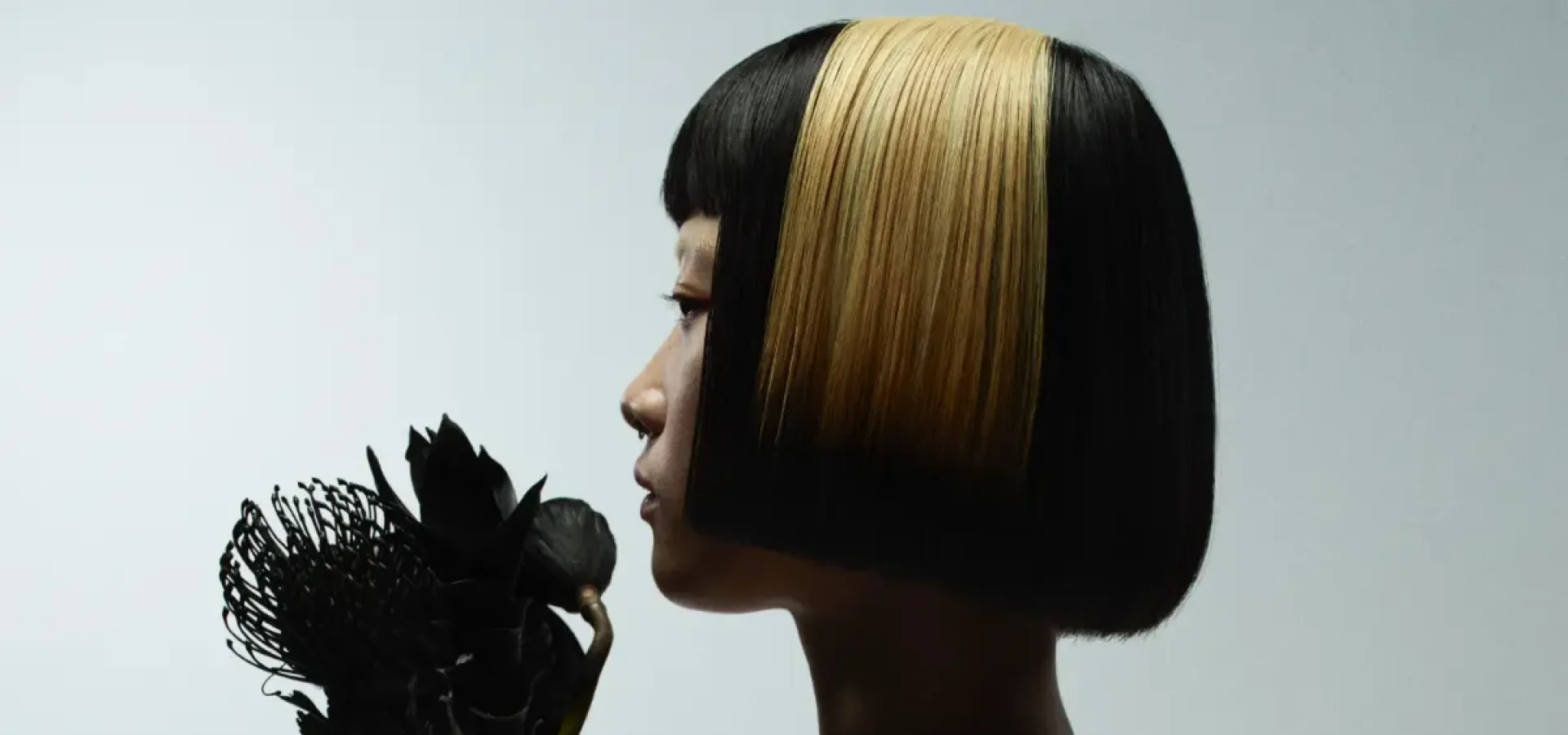 Model with blunt bob hair exploring refined simplistic beauty with the Eclipse collection by Marlon Hawkins.