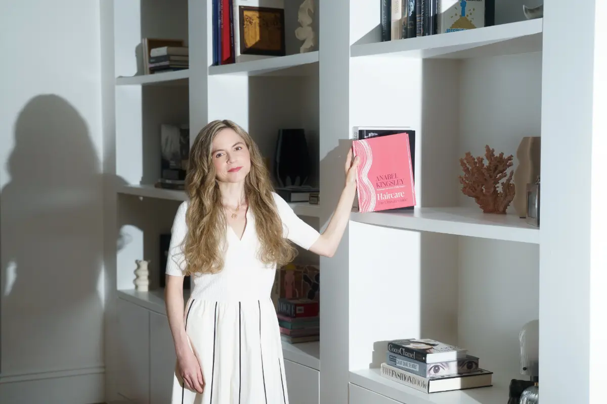 Anabel Kingsley puts her book on a shelf.