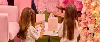 Kids play with gift bags at a charity event.