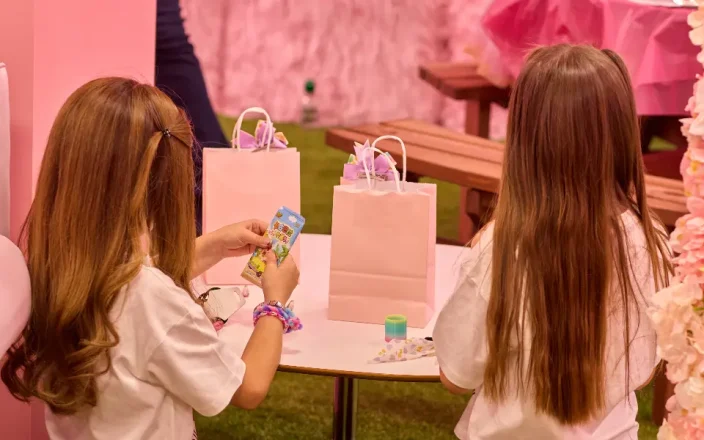 Kids play with gift bags at a charity event.