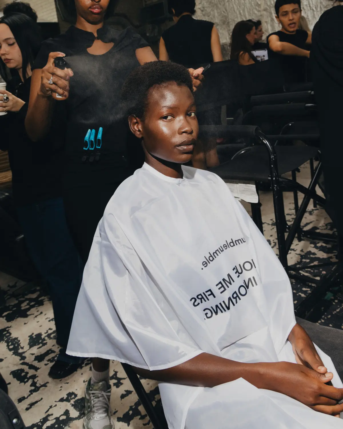 Model having hair styled at Fashion East LFW.