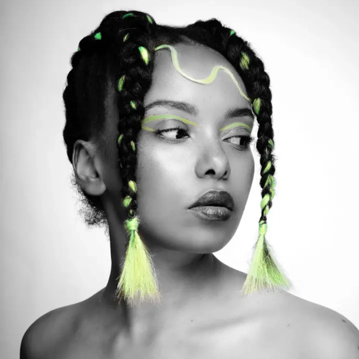 A model with creative braids in textured hair.