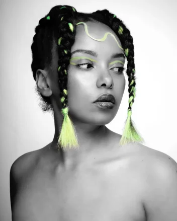A model with creative braids in textured hair.
