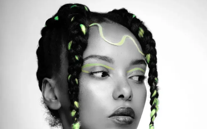 A model with creative braids in textured hair.