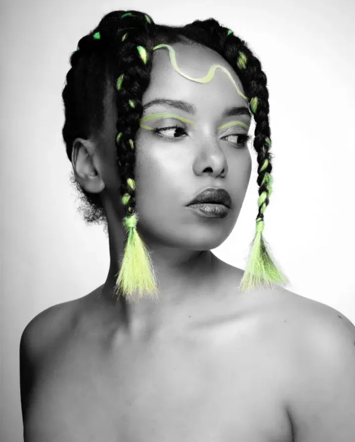 A model with creative braids in textured hair.