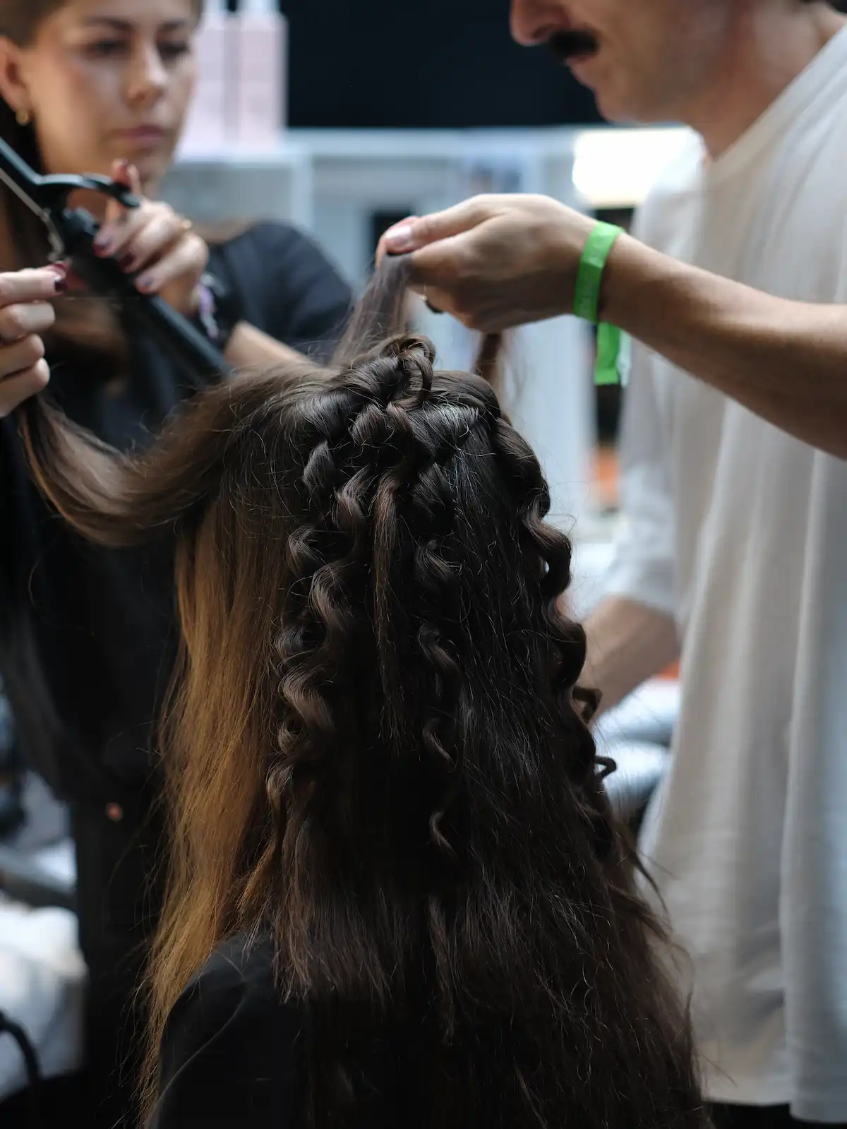 Model gets her brunette hair done backstage at Erdem SS27.