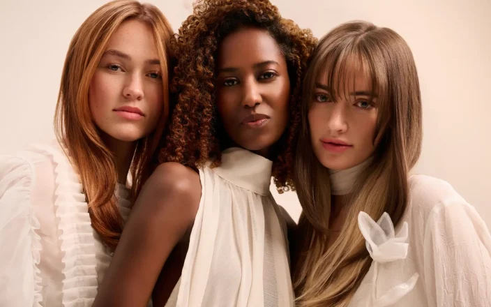 Three models with Golden Hour highlights by Aveda.