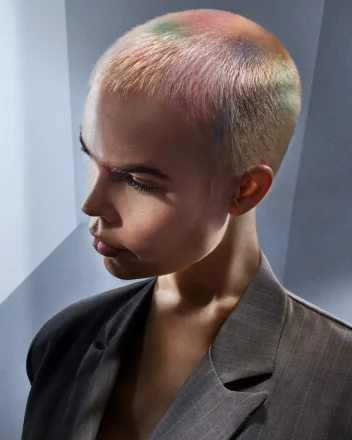 Model with buzzcut hair and marble effect colouring.