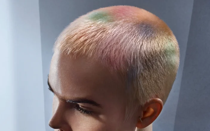 Model with buzzcut hair and marble effect colouring.