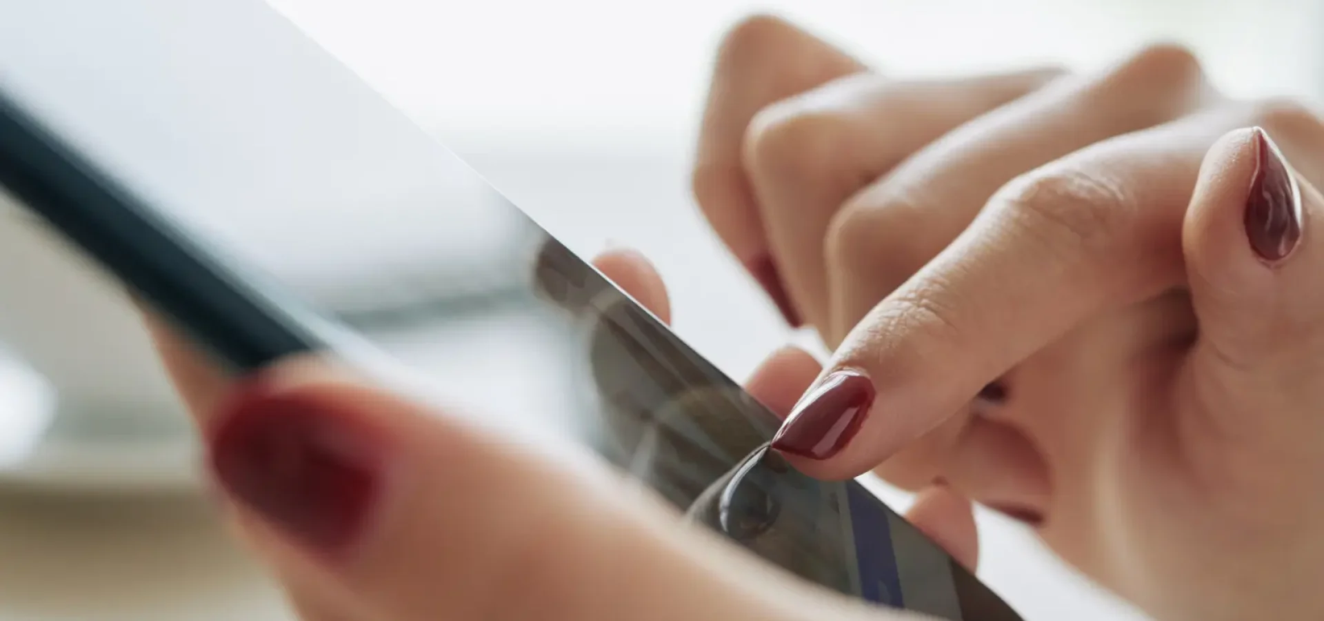 Hands holding a mobile phone.