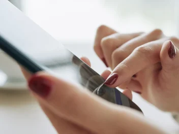 Hands holding a mobile phone.