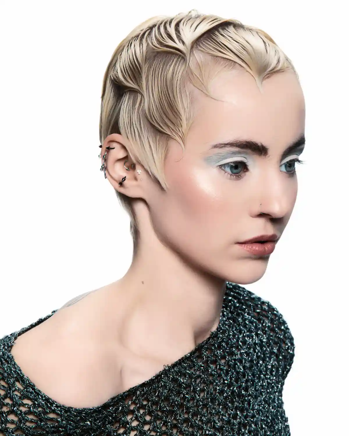 Chris Grimley’s Motion collection featuring a sculpted platinum blonde pixie cut with sleek, defined texture and fluid movement.