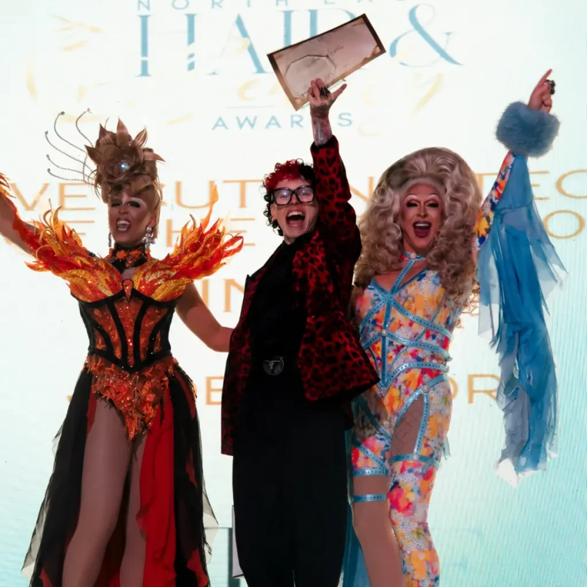 OSMO Ambassador Jude Taylor NE Hair & Beauty Awards Winner on the stage getting an award.