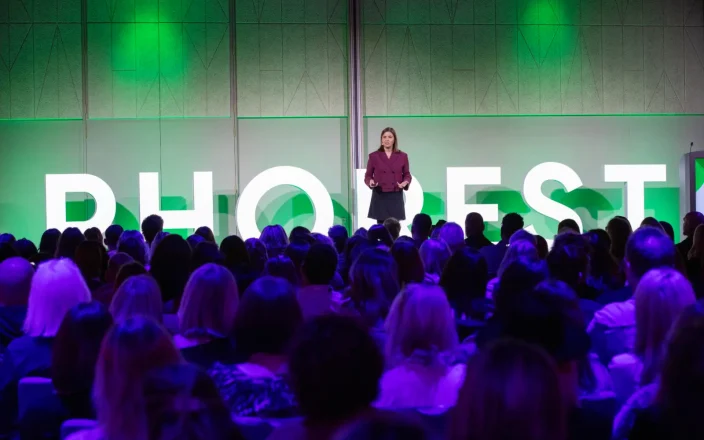 Speaker stands on the stage at the Phorest Salon Summit.