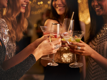 Women cheers with glasses at a festive party.