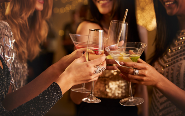 Women cheers with glasses at a festive party.