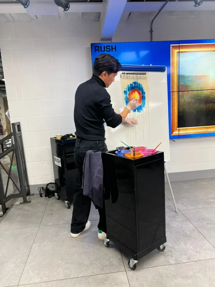 Hairdresser demonstrating colour techniques at an exhibition stand.