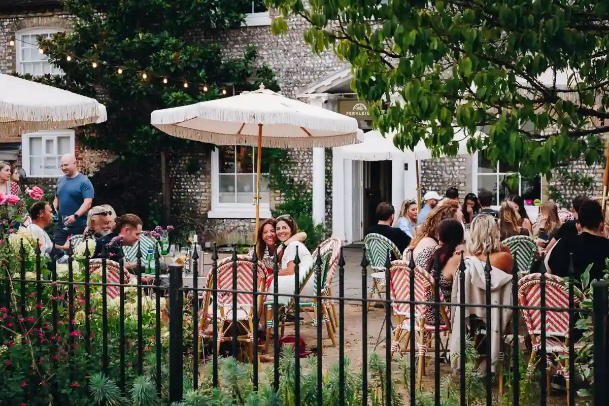 Guests sit under parasols in the salon's garden at Q Fest.