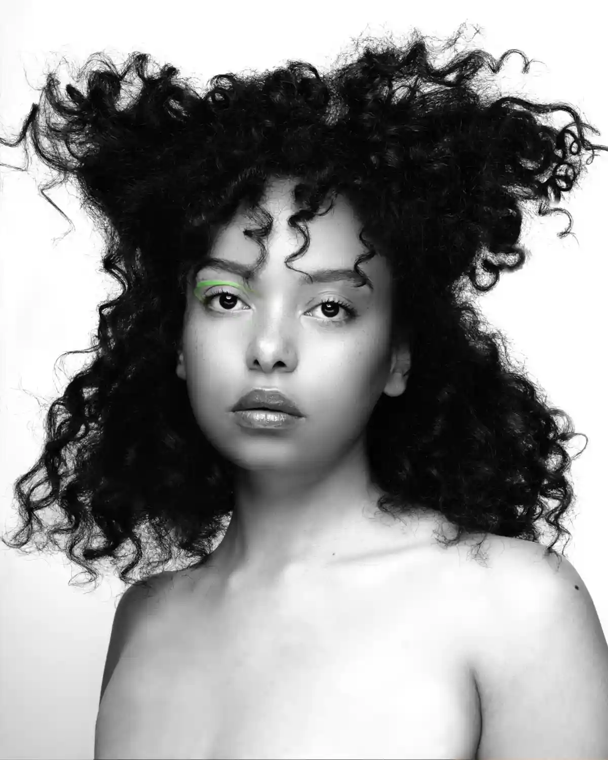 Model with textured hair highlighting natural movement.