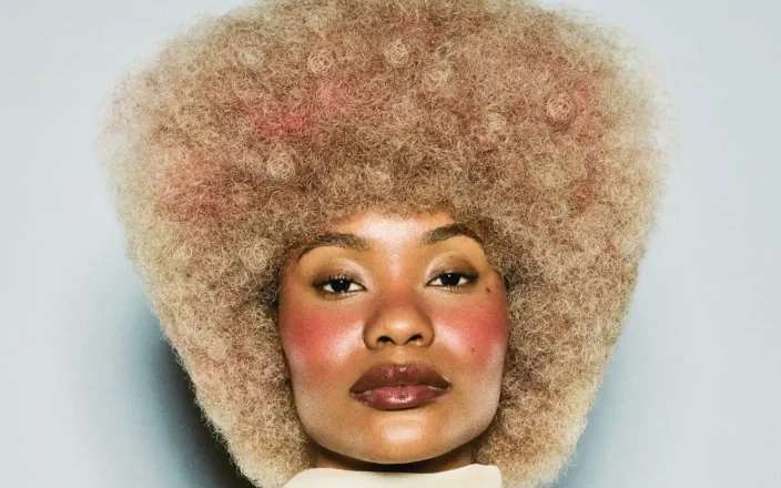 Model with short curly blonde hair part of the Weight We Wear collection by Elle Foreman.