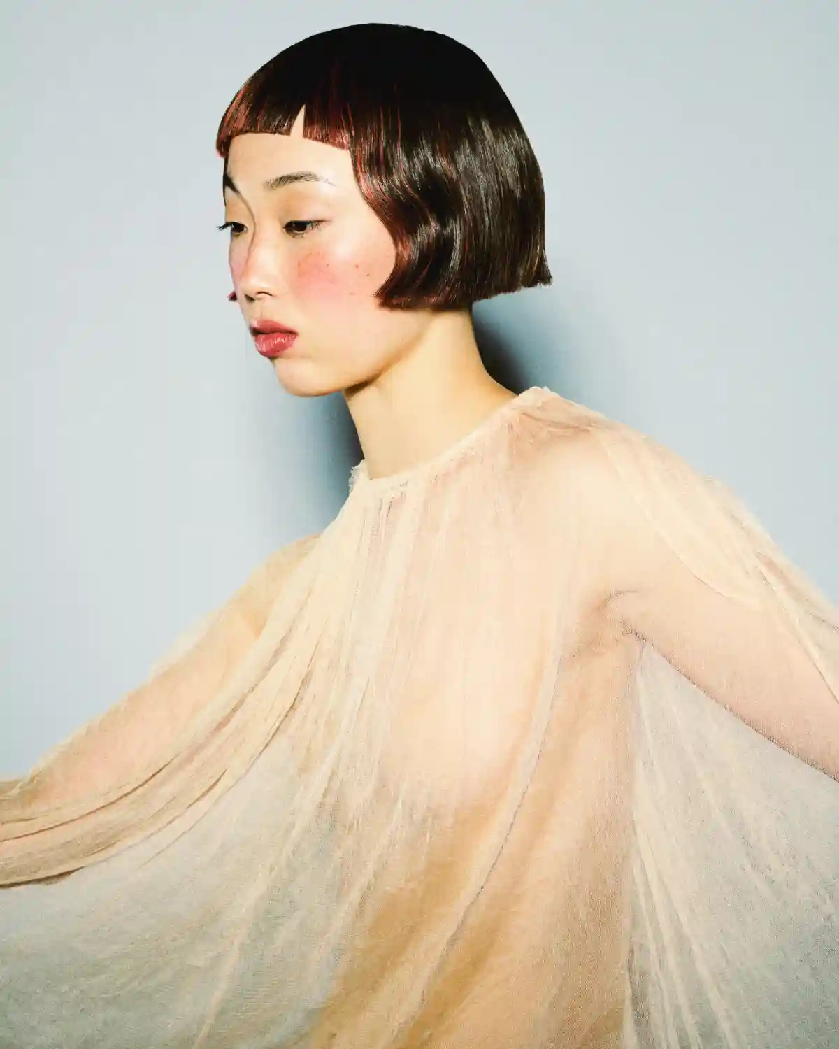 A model with a short brown haircut part of the Weight We Wear collection by Elle Foreman.