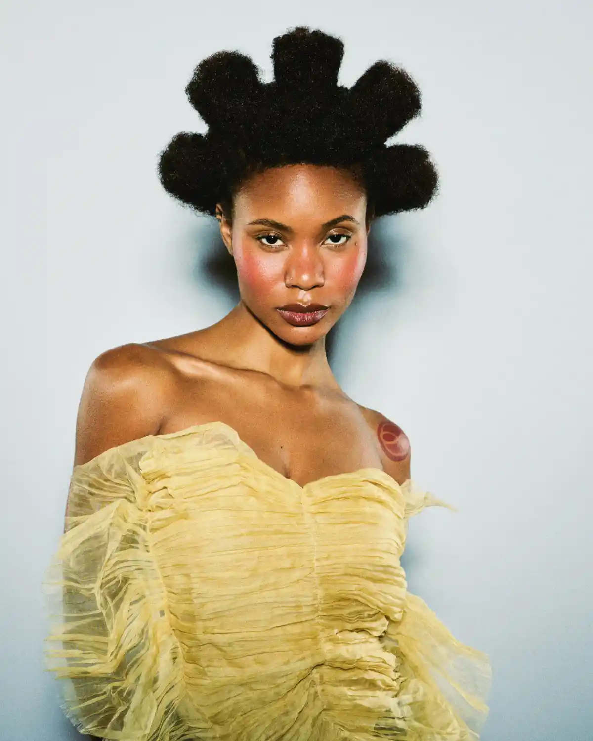 Model with divided short curly hair part of the Weight We Wear collection by Elle Foreman.