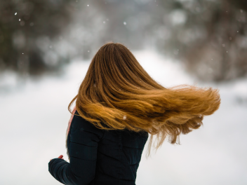 Model with long hair in winter weather.