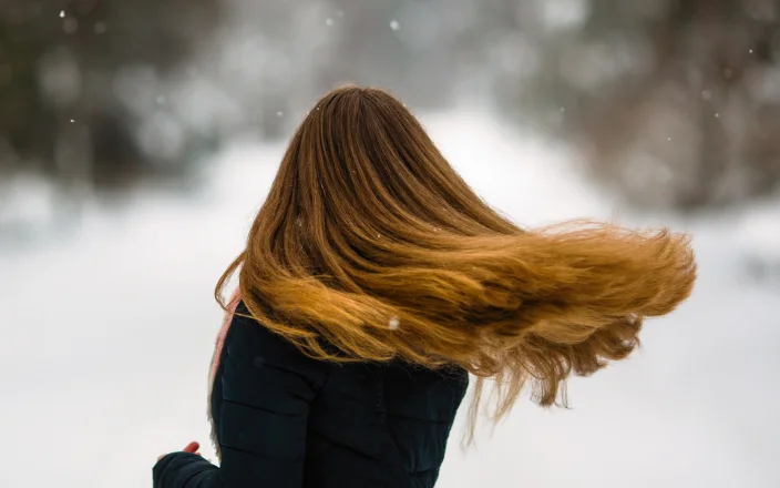 Model with long hair in winter weather.