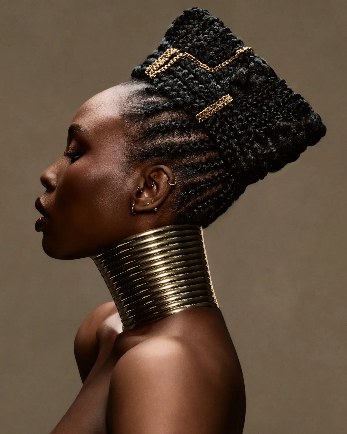 Afro-textured sculptural braided hairstyle with gold adornments from Chris Grimley’s Future Ancestry collection.