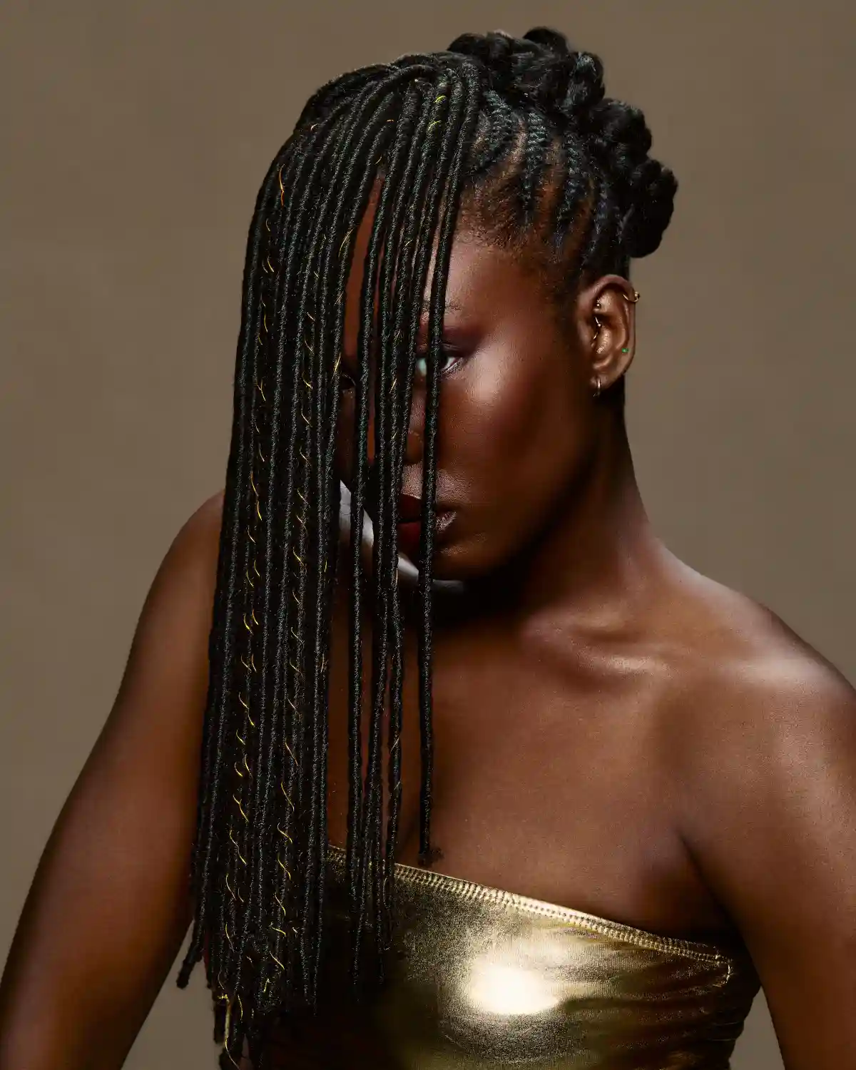 Afro-textured braided hairstyle with gold detailing from Chris Grimley’s Future Ancestry collection.