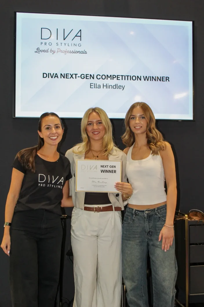 Winners stand with a certificate at Salon International.