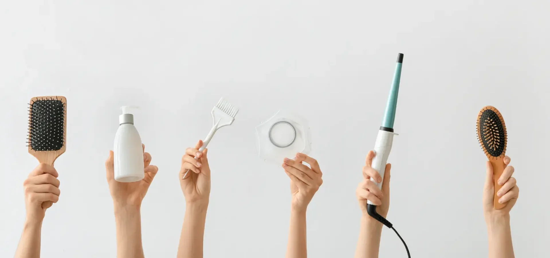 Hands holding hair tools