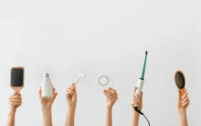 Hands holding hair tools