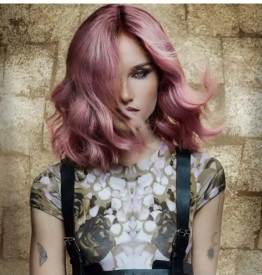 Model with a sleek long bob with soft, romantic waves and a pink-to-rosé gradient.