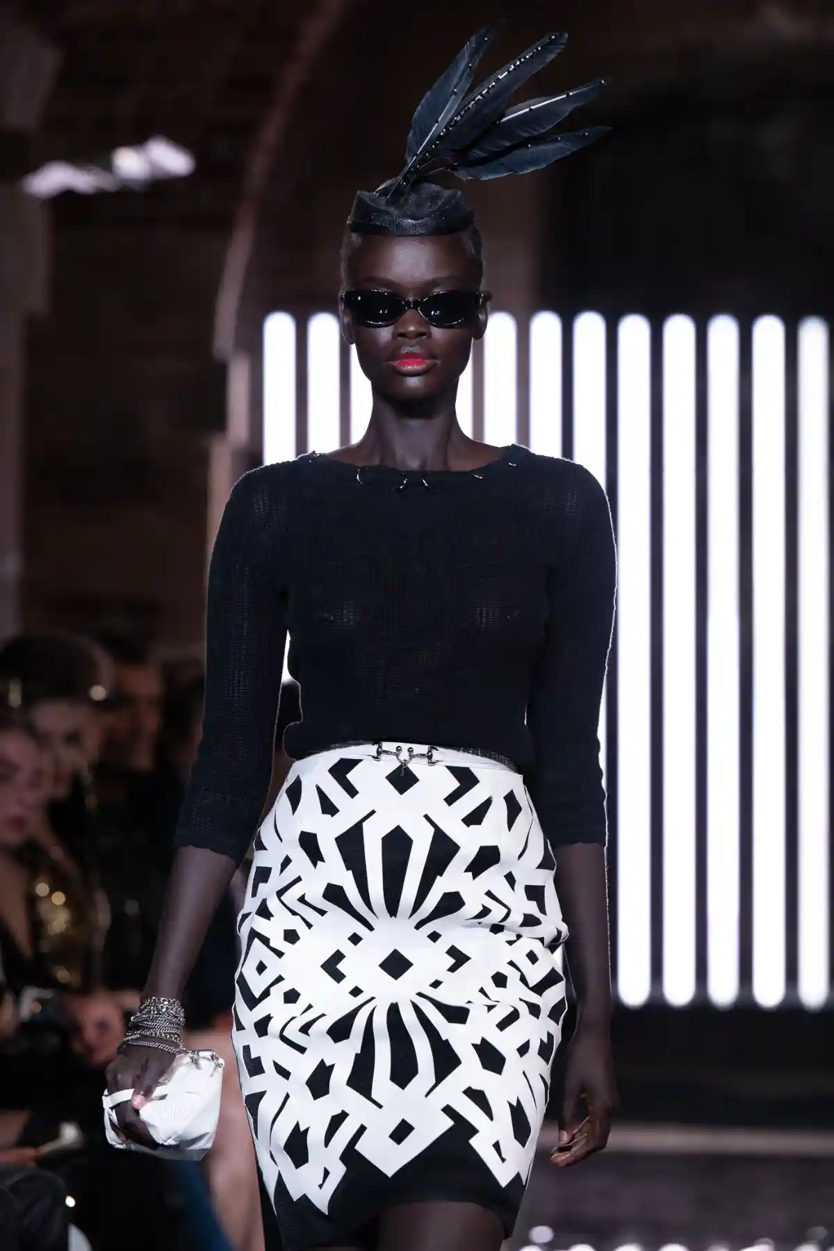 Model with feathers and wearing monochrome at TONI&GUY X John Richmond SS27