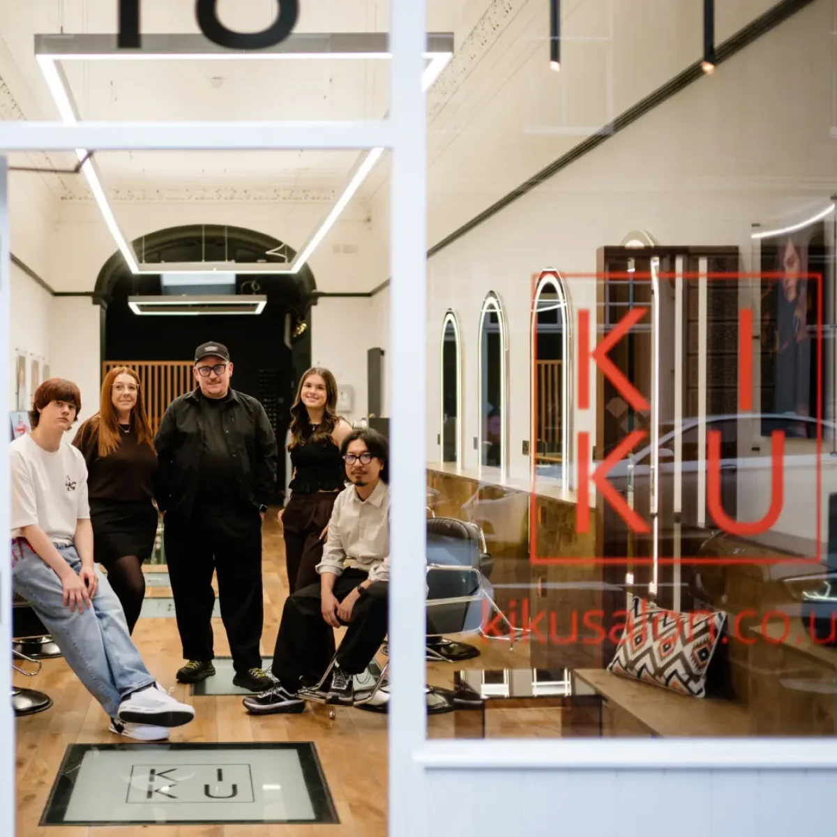 Staff from KIKU salon inside the salon as photo is taken from the buildings entrance.