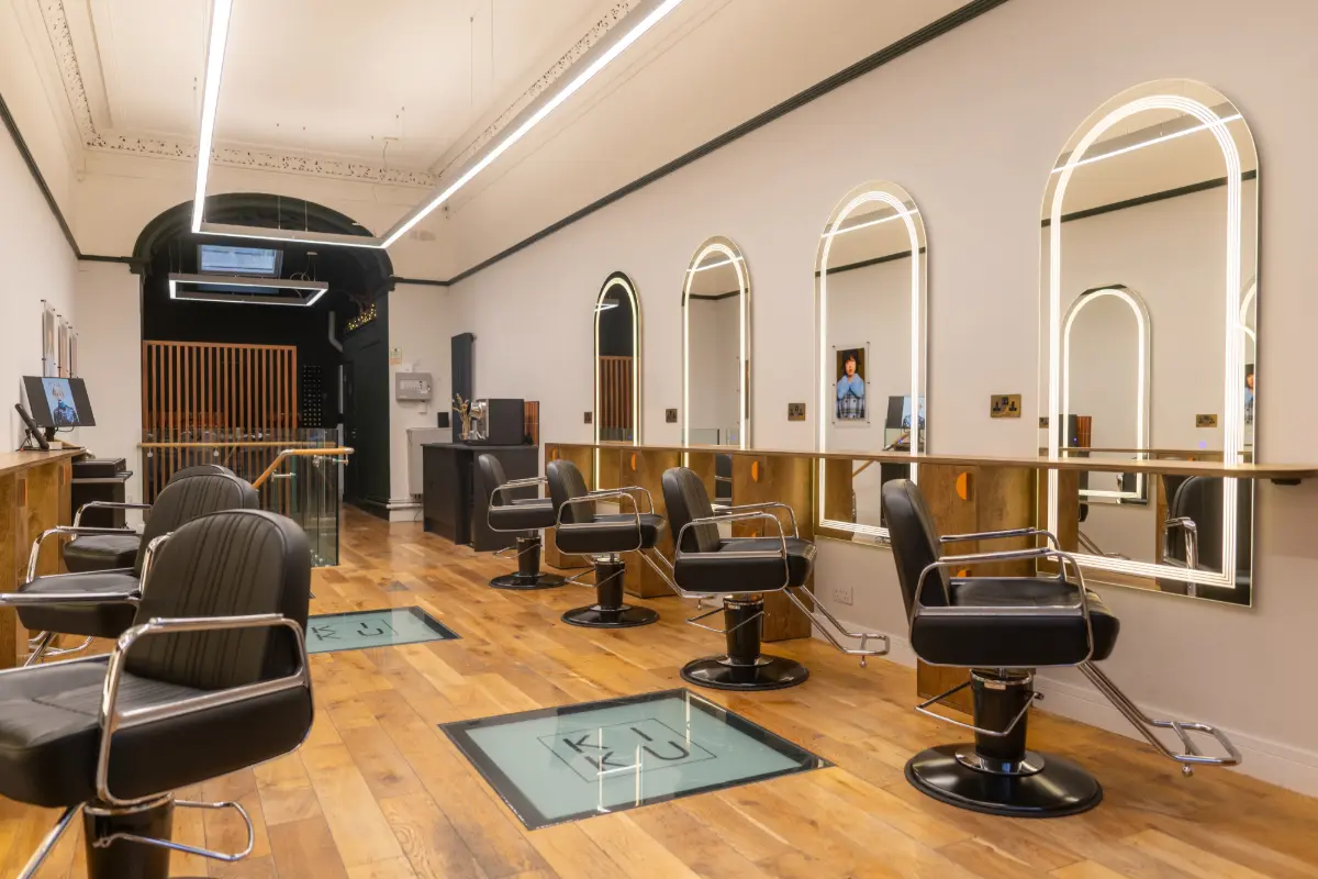 Styling stations with illuminated mirrors inside KIKU Salon.