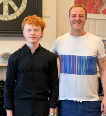 Mark Woolley standing next to student doing a London placement.