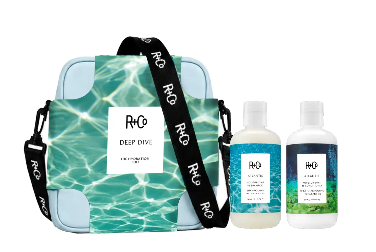 Bottle of R+Co Atlantis Moisturising B5 Shampoo and Moisturising B5 Conditioner next to a gift bag.